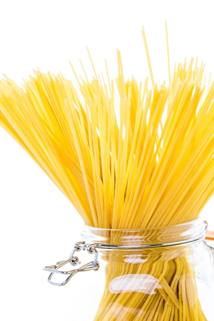 Organic yellow pasta on a white background.