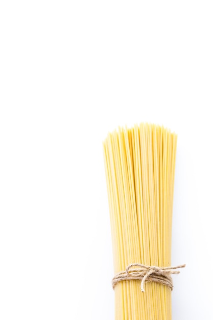 Organic yellow spaghetti pasta on a white background.