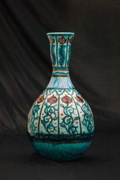 Oriental antique ceramic vase on a black background closeup