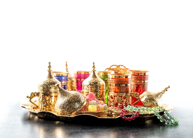 Oriental hospitality. Arabic tea coffee table with golden cups. Ramadan kareem