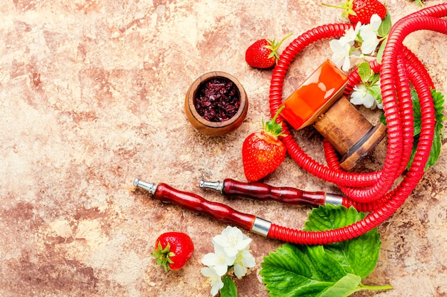 Oriental smoking hookah with strawberry tobacco. Berry hookah tobacco.