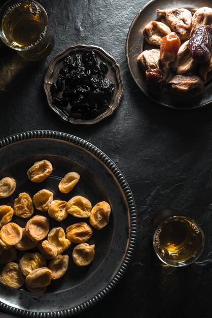 Oriental style tea with dried apricots dates and raisins on a stone table