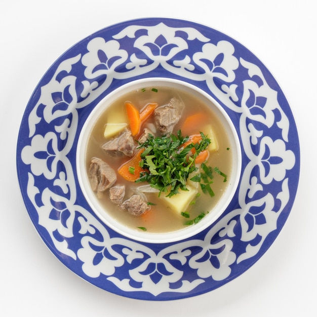 Oriental Uzbek soup in traditional plate