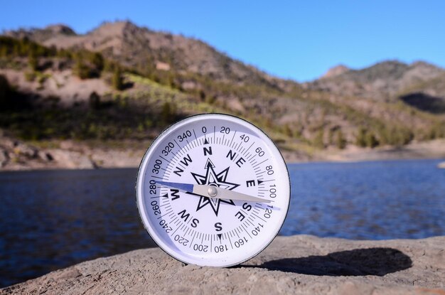 Orientation Concept - Analogic Compass Abandoned on the Rocks