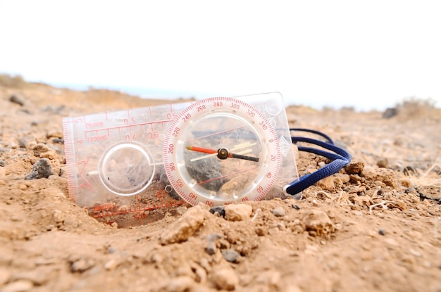 Orientation Concept Metal Compass on a Rock in the Desert