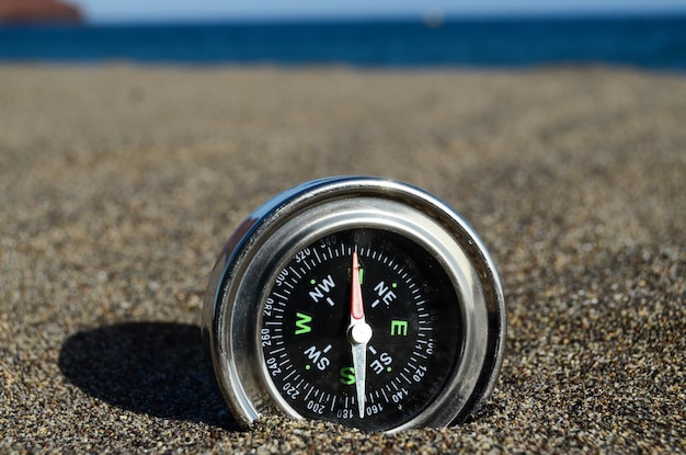 Orientation Concept One Compass on the Beach near the Atlantic Ocean