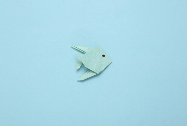 Photo origami fish on a blue background