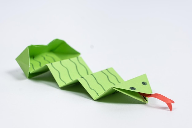 Origami green snake DIY paper crafts white background