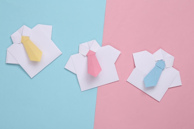 Origami shirts with ties on a bluepink pastel background Leadership teamwork business concept