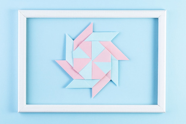 Origami Star. Made with square sheets of paper and white wood frame.