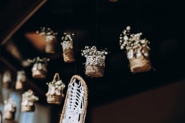 Original wedding floral decoration in the form of minivases and bouquets of flowers hanging