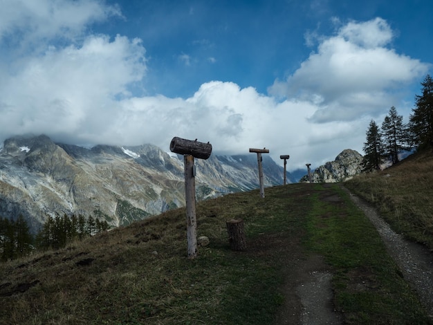 original wooden pointers of mountain peaks along the mountain road Alps Wooden trail pointer with m