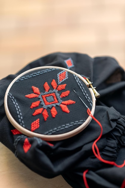 ornament embroidery on black fabric in red and gray colors