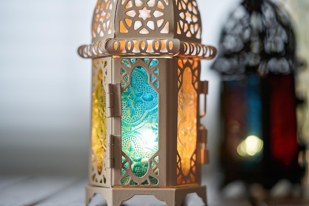 Ornamental arabic lantern with burning candle glowing in dark\
muslim holy month ramadan kareem festive