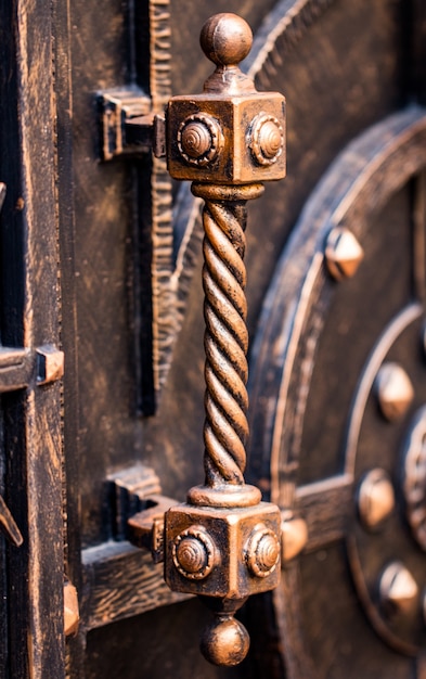 Ornate wrought-iron elements of metal gate decoration.