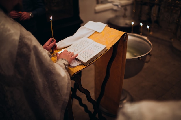 Photo orthodox christian priest and holy bible in the church. epiphany ceremony rite.