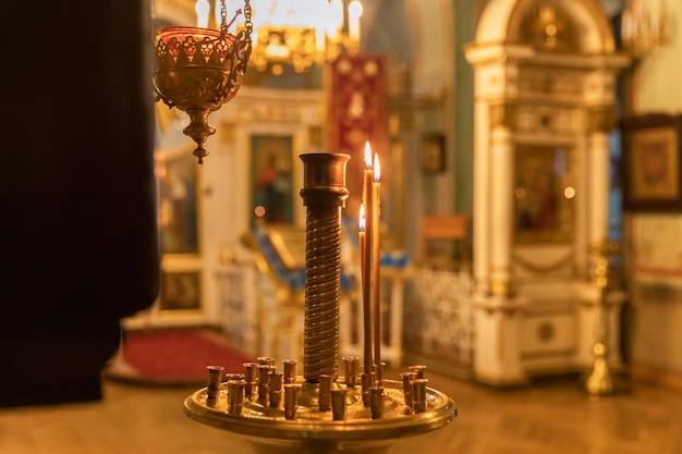 Orthodox church christianity festive interior decoration with burning candles and icon in traditiona