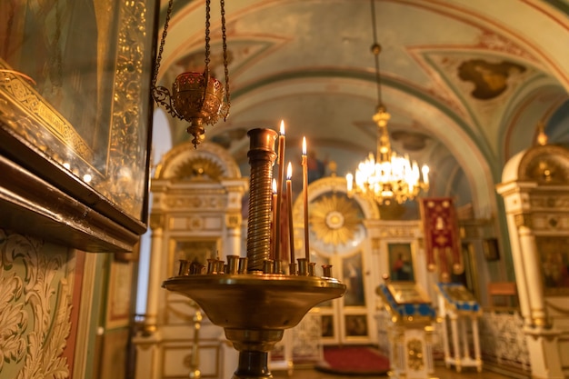 Orthodox church christianity festive interior decoration with burning candles and icon in traditiona.