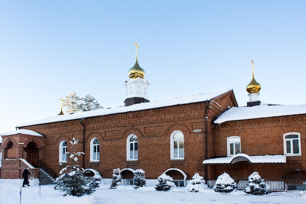 Orthodox church near the bell tower in winter in Russia