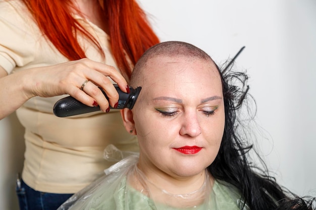 An orthodox jewish hasidic woman cries as she shaves her head\
after her wedding horizontal photo