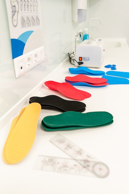 Orthopedic insole. The orthopedist works with the patient. Orthopedic clinic. Choice of insoles in an orthopedic clinic. The orthopedist offers the insole to the patient Foot care