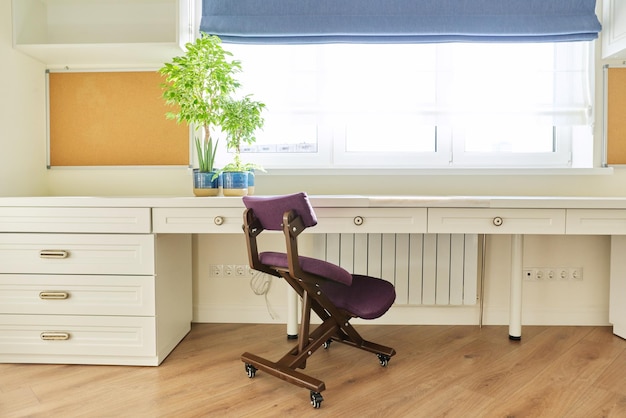 Orthopedic knee chair in the interior of children's room home office