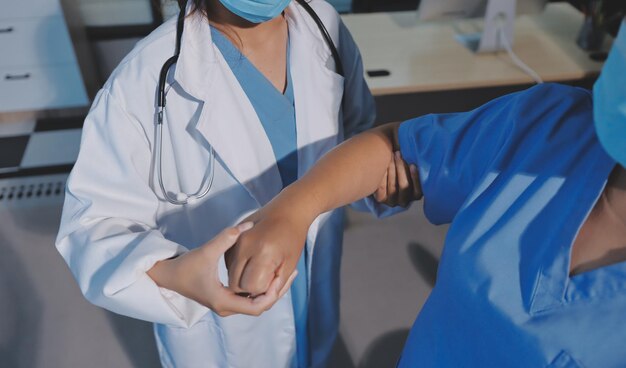 Orthopedist examining patient in hospital