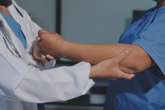 Orthopedist examining patient in hospital
