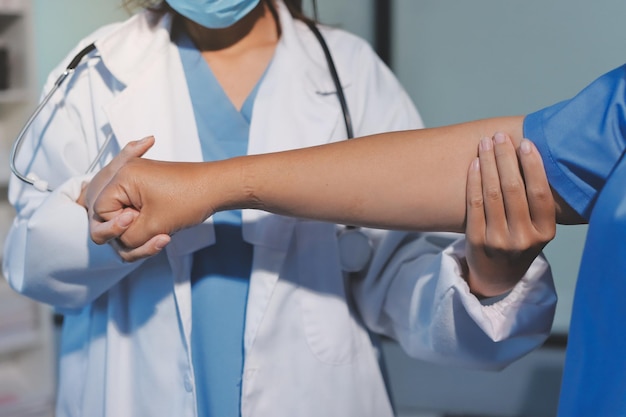 Orthopedist examining patient in hospital