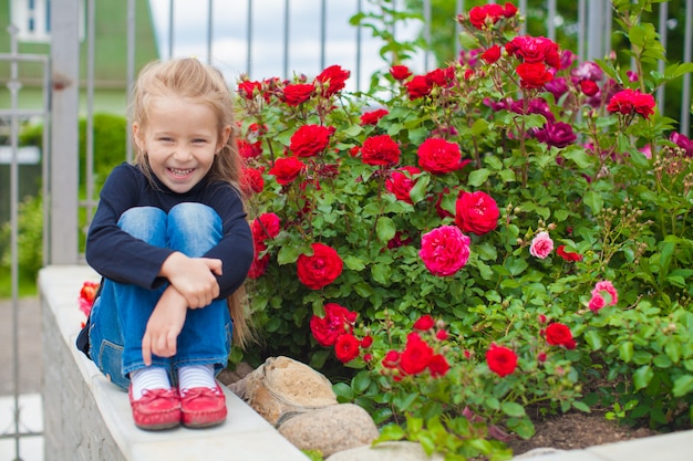 Ortrait van schattig klein meisje in de buurt van de bloemen in tuinhuis