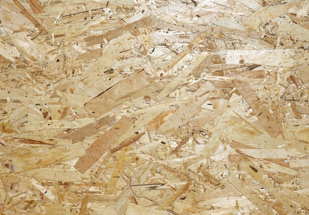 OSB is building material from wooden panel made from of pressed sandy brown wood shavings