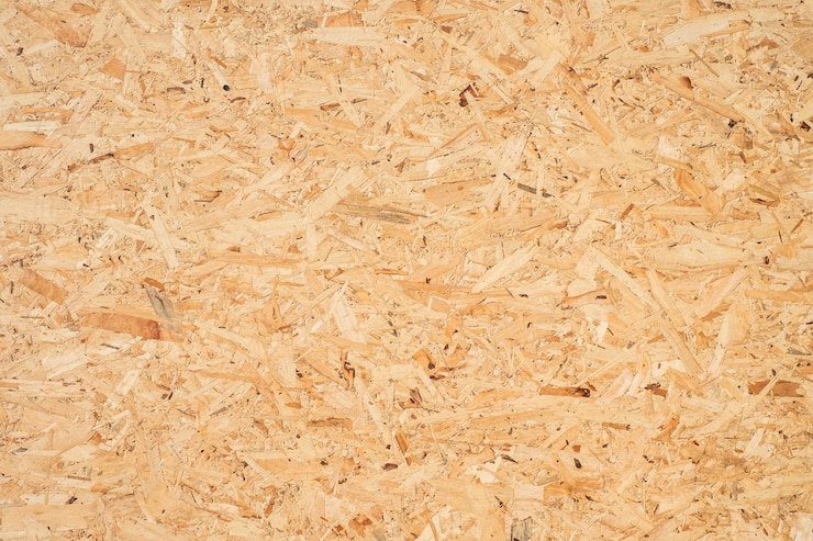 Photo osb sheet is made of brown wood chips pressed together into a wooden floor.