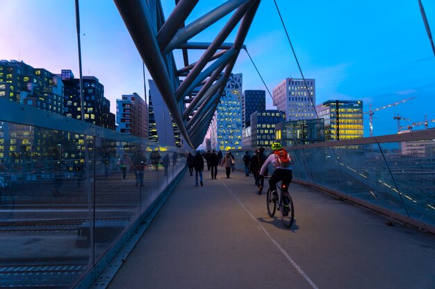 OSLO, NORWAY - Jan 06, 2017: Cyclist and Walking People on the Akrobaten Pedestrian Bridge