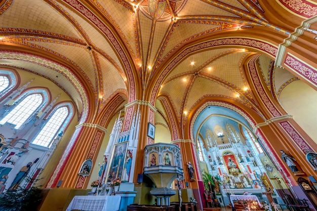 Ossava belarus august 2020 interior dome and looking up into a\
old gothic catholic church ceiling