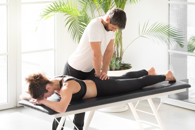 Osteopath doing sacrum mobility treatment