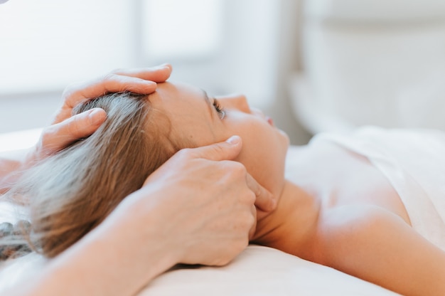 Photo osteopath hands does therapy for girl. pediatric osteopathy treatment session. alternative medicine