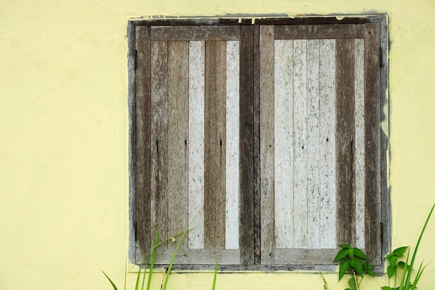 Oud houten raam op cementmuur