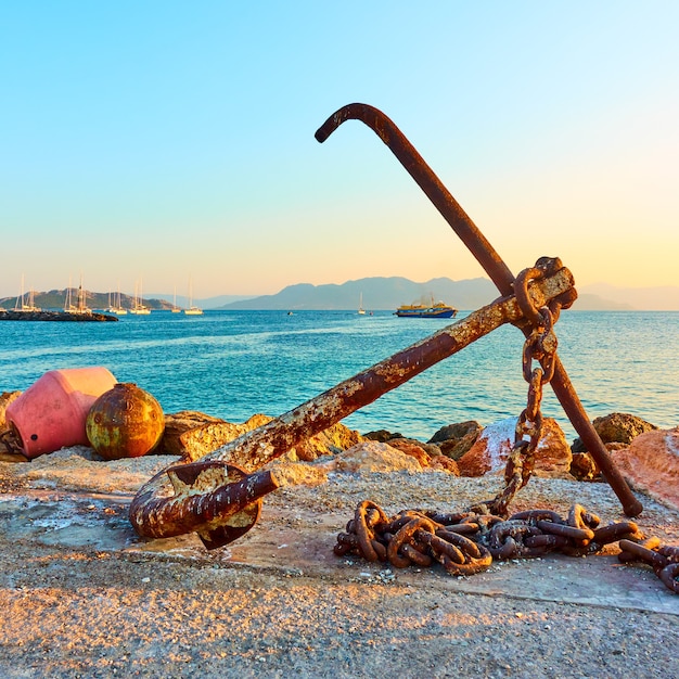 Oud schipanker op pijler in haven van Aegina, Saronische Eilanden, Griekenland