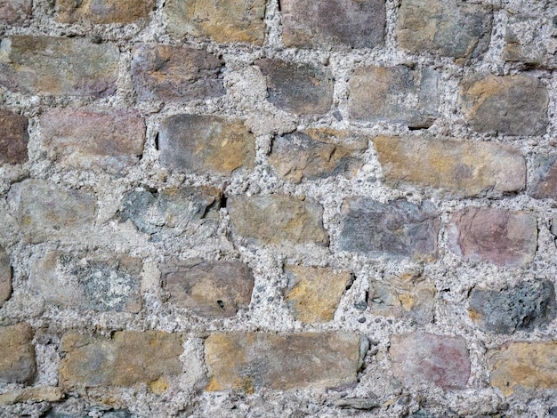 Oud stenen muurpatroon dichtbij achtergrond oude bakstenen oppervlak