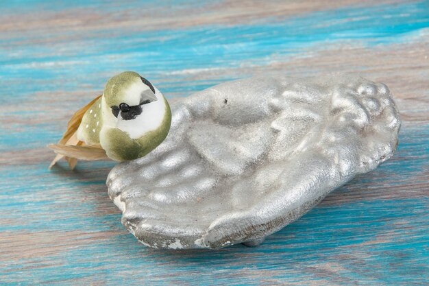 Oude aluminium vogelvoeder, vogel drinkbak, handen decoratieve kom op blauwe houten achtergrond. Kopieer ruimte voor tekst, fotografie rekwisieten.