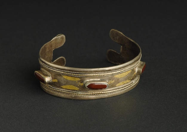 Oude antieke armband met stenen op zwarte achtergrond. Midden-Aziatische vintage sieraden