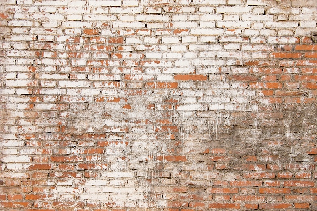 Oude bakstenen muur met witte verf achtergrondtextuur