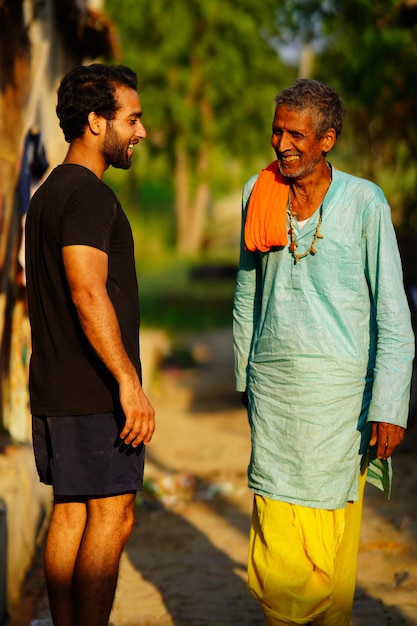 Oude en jonge man praten met elkaar in India