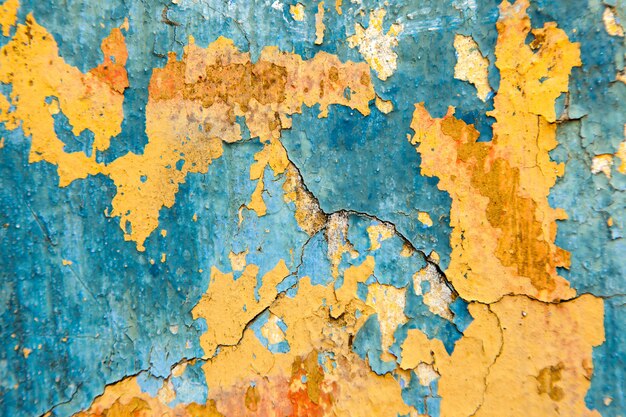 Oude geschilderde muur - blauwe en gele textuur