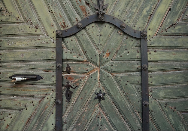 Oude groene houten deur close-up fragmenten van architectuur van oude gebouwen Groene houttextuur