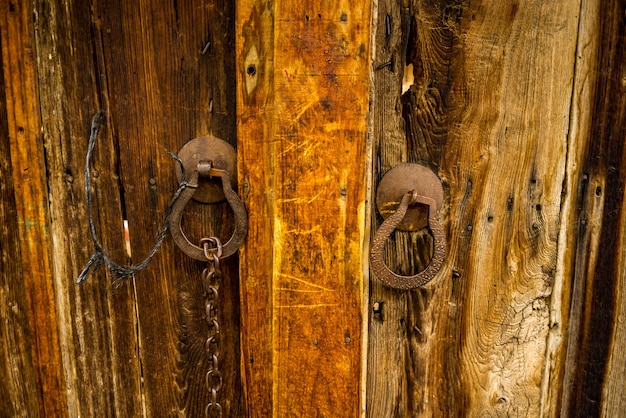 Foto oude houten deur met oude ijzerkloppers