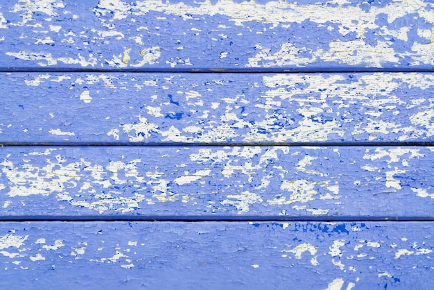 Oude houten planken met gebarsten blauwe verf