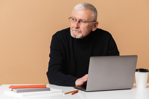 Oude man met laptop portret