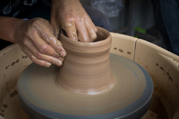 Oude pottenbakker die een nieuwe ceramische pot creeert