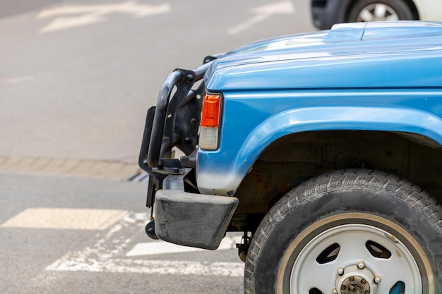 Oude SUV op de parkeerplaats blauwe auto